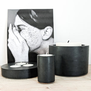 concrete and wax black concrete pot with threewick soy candle lifestyle shot