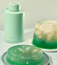 Load image into Gallery viewer, Frank Green 68oz 2L Ceramic Reusable Bottle with Straw Lid in Mint Green Lifestyle Shot
